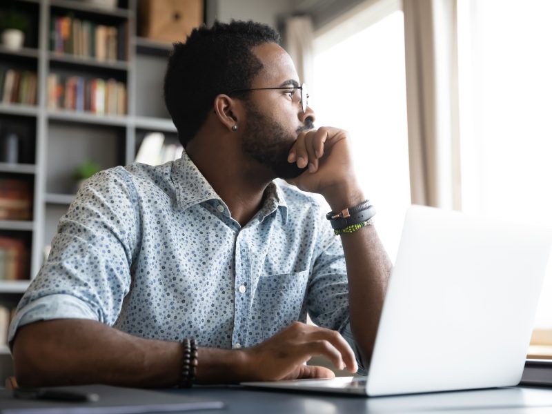 Thoughtful,Serious,African,Professional,Business,Man,Sit,With,Laptop,Thinking